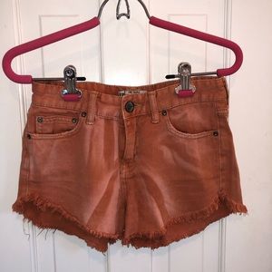 FREE PEOPLE distressed burnt orange denim shorts!